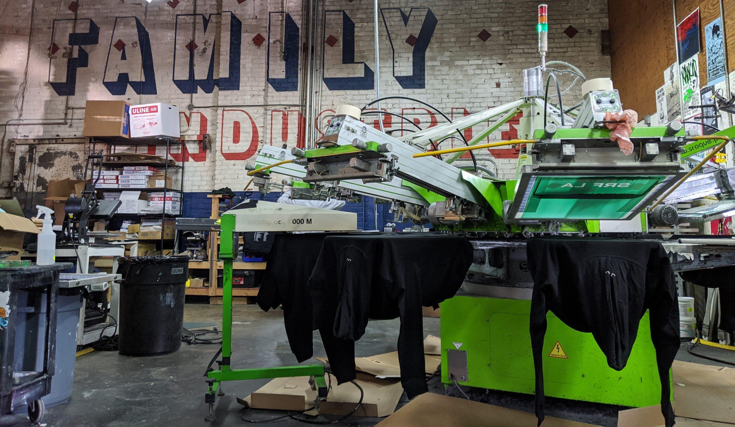 A ROQ screen printing press at work in Family Industries in 2019.
